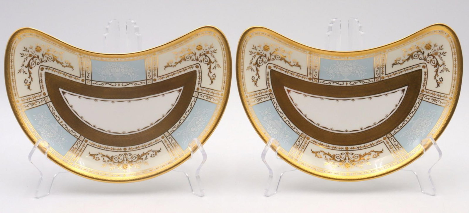 2 Pc. Vintage Mintons French Enamel Crescent Shaped Sandwich plates: 2 Pc. Vintage Mintons Bone China Crescent Shaped Sandwich plates. Measures approx. - 8 1/2" in width and 5" in length. Portrays a greco-style center pattern French enamel with gilt edging and baby blu