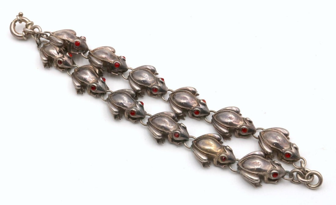 Vintage Sterling Silver 2-Strand Frog Bracelet: Vintage Sterling Silver 2-Strand Frog Bracelet. Measures approx. - 8 1/4" long. Weight approx. - 118.6 grams. Couple of frogs have miscolored eyes. Have a similar item to sell? Contact us at info&