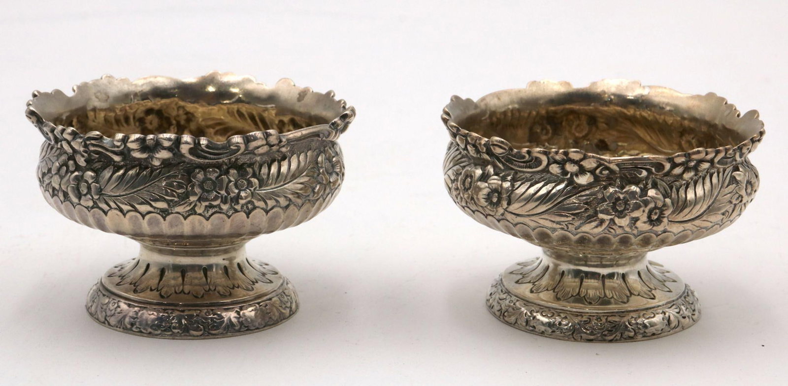 Antique Tiffany & Co. Sterling Silver Footed Salt Cellars: Antique Tiffany & Co. Sterling Silver Footed Salt Cellars. Depicting floral design throughout. Measures approx. - 1 3/4" high x 3" diameter. Weight approx. - 4.81 troy oz. Marked 5006 6222