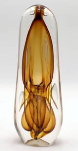 American Studio Art Glass Sculpture Paperweight: American Studio Art Glass Sculpture Paperweight in amber and clear glass.Measures approx. 9 1/4" height, 3 1/4" in width. Marked 77699. Overall good condition with some scratches on the base.