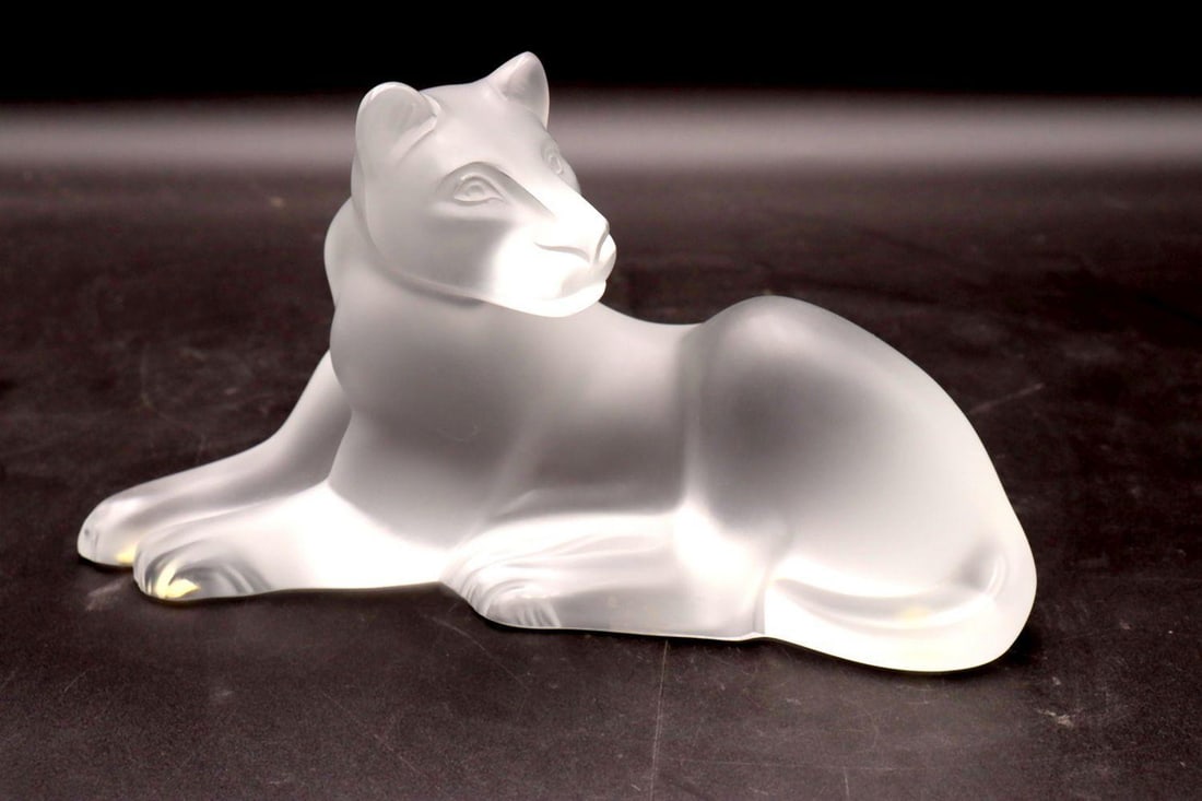 Lalique "Simba" Crystal Sculpture: Lalique France "Simba" Crystal Sculpture. Depicting a lioness. Measures approx. - 5 1/4" high x 10" long. With original box, box is sold as is. Have a similar item to sell? Contact us 