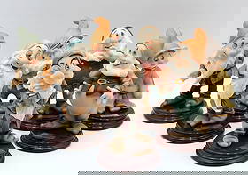 Giuseppe Armani Snow White's "7 Dwarves" Ceramic Figurines: Giuseppe Armani (Italian, 1935–2006) Set of Seven “Snow White and the Seven Dwarfs” Ceramic Figurines with Presentation Base Florence, Italy, late 20th century A complete se