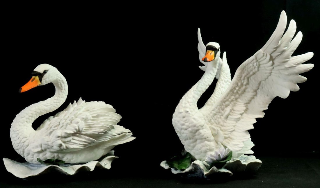 Boehm "Swan" Male and Female Porcelain Sculptures: Boehm (American) Mute Swan Pair — Male and Female Model No. 130 Porcelain Sculptures Male Approx. 16 in. high × 16 in. wide × 12 in. deep Female Approx. 11 1/2 in. high × 13 in. l