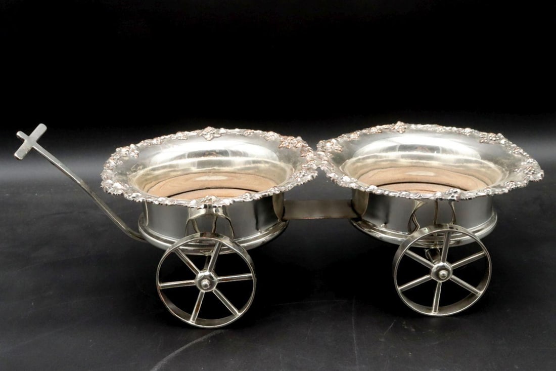 20th C. Silver Plated Double Wine Bottle Cart: Victorian-Style Silver-Plated Double Wine Bottle Cart, Early–Mid 20th Century This silver-plated rolling wine cart is designed to hold two bottles, each set into a circular silver-plated frame w