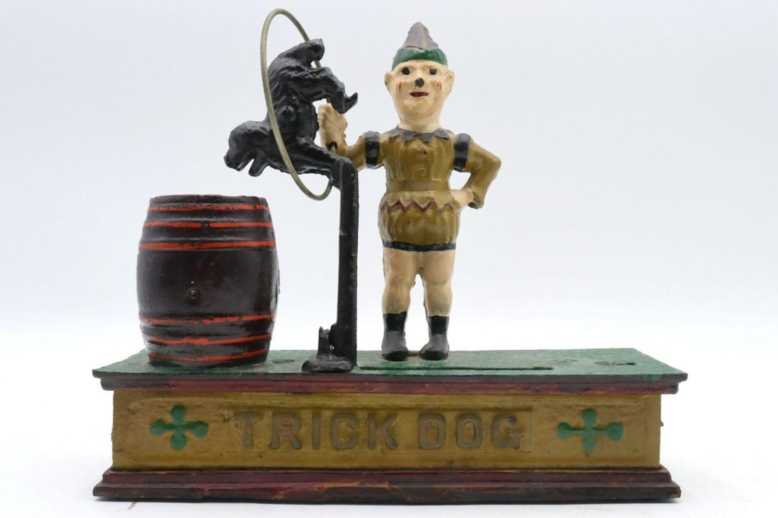 Cast Iron "Trick Dog" Mechanical Coin Bank: CAST IRON “TRICK DOG” MECHANICAL COIN BANK (REPRODUCTION) Made in Taiwan, mid–20th century 8¾ in. D x 2¾ in. W x 7 in. H (22.2 x 7 x 17.8 cm) A colorful cast iron