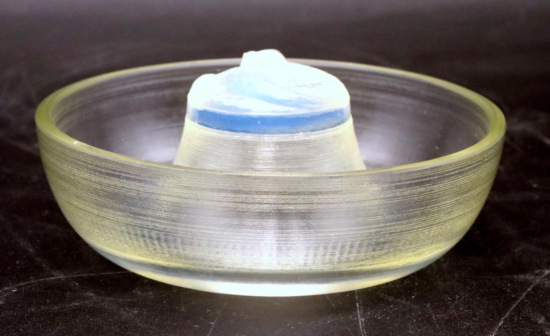 René Lalique "Serpent" Glass Ashtray: René Lalique (French, 1860–1945) Serpent Ashtray, molded glass Circa 1920 Model no. 276 Measurements: 2 in. high x 4 1/2 in. diameter Molded clear and opalescent glass ashtray of circula