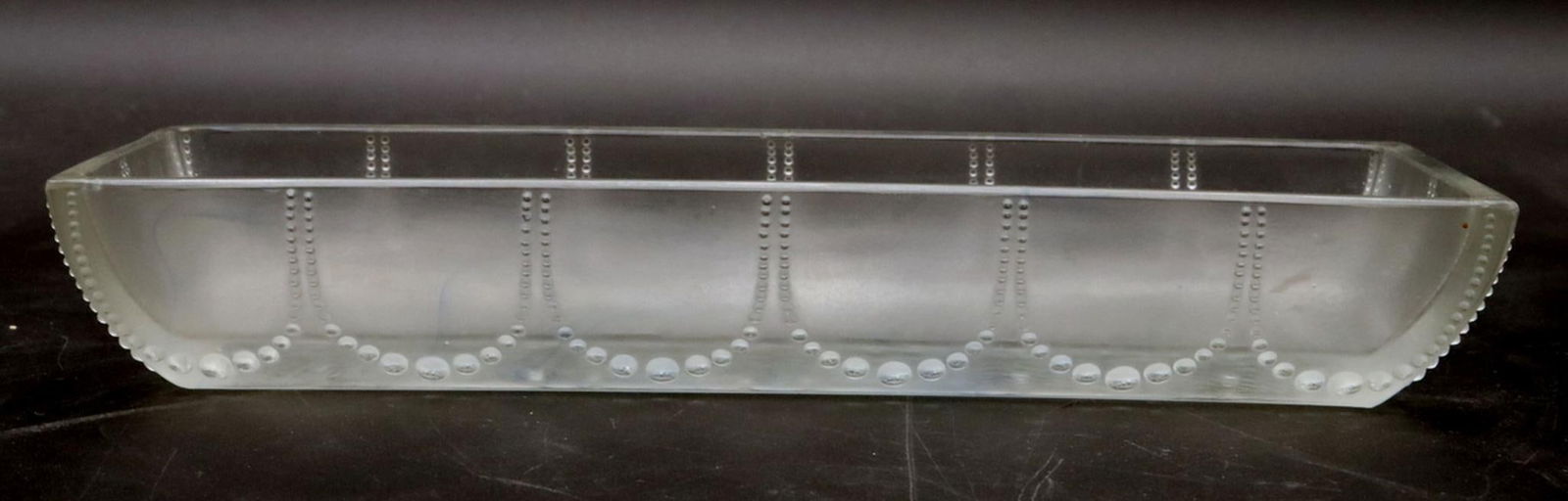 René Lalique "Perles" Glass Dish: René Lalique (French, 1860–1945) Perles Dish, molded glass Measurements: 1 1/2 in. high x 9 1/8 in. long Rectangular molded glass dish decorated with the Perles pattern, featuring continu