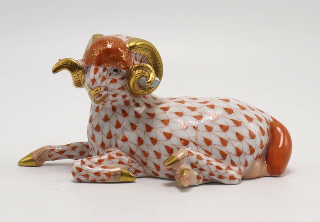 Herend Porcelain Ram Figurine in Rust Orange: Hungarian Herend Porcelain Ram Figurine Circa 2000 Measurements: 4 1/2" W x 2 1/2" D x 2" H Hand-painted porcelain with gilt decoration. A Hungarian porcelain ram figurine by the Herend Po
