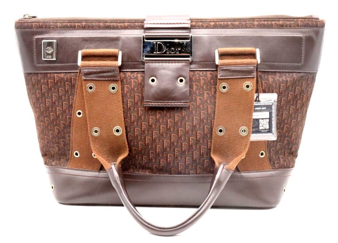 -/.e,89 Brown Canvas Tote Bag: Christian Dior “Street Chic” Brown Canvas Tote Bag with Silver-Tone Hardware Measurements: 14" W x 10" L x 5 1/2" D Brown canvas tote bag by Christian Dior from the Street Chic
