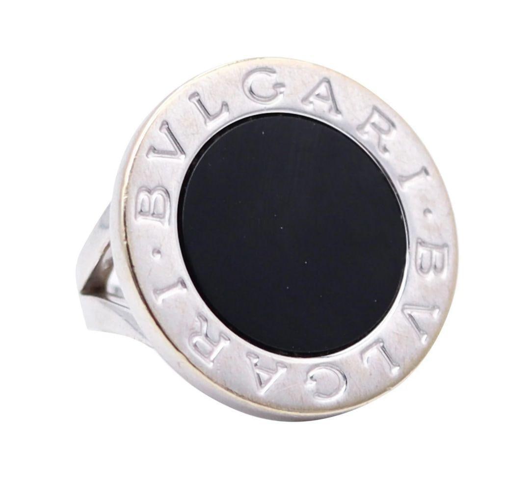 Bvlgari Signature 18K Onyx Cabochon Cut Cocktail Ring: Bvlgari (Italian, founded 1884) Signature 18K Onyx Cabochon Cut Cocktail Ring Diameter 26 mm (1.02") Crafted in Milano-Roma, Italy, this signature cocktail ring from the Bvlgari-Signature collecti