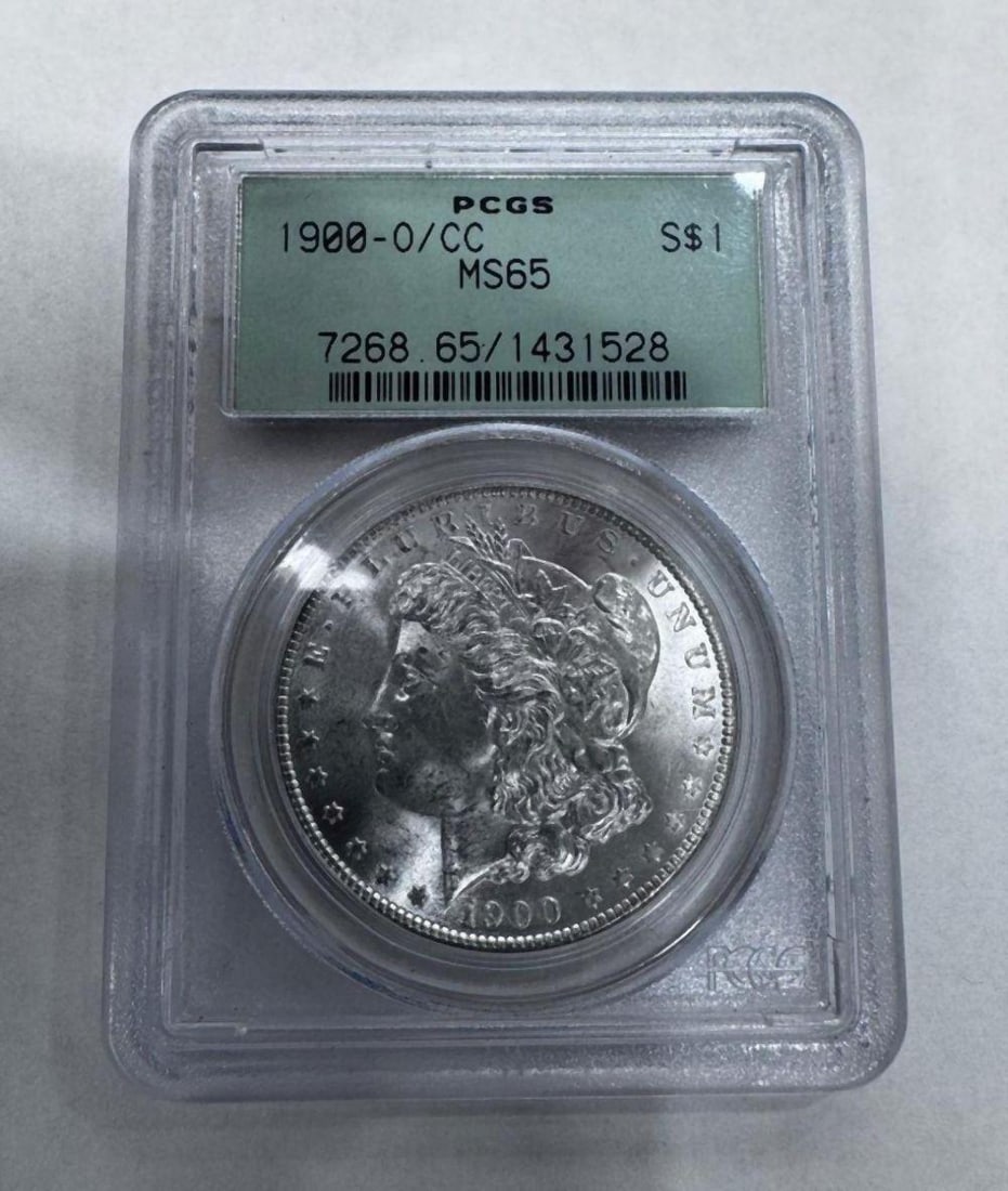 1900-O/CC Morgan Silver Dollar PCGS MS65: 1900-O/CC Morgan Silver Dollar PCGS MS65 Certified by Professional Coin Grading Service (PCGS) as Mint State 65. New Orleans mint issue featuring the desirable O/CC overmintmark variety. This example