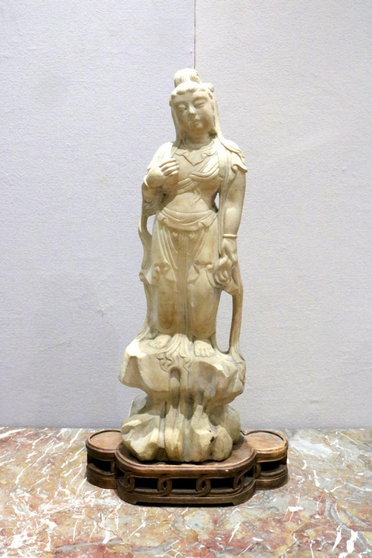 Vintage Chinese Guan Yin Carved Stone Sculpture: Chinese Guan Yin Carved stone sculpture 20th Century 28" H x 9" W x 7" D Pedestal: 3 1/2" H x 16 1/2" W x 8" D Vintage carved stone sculpture depicting Guan Yin, the