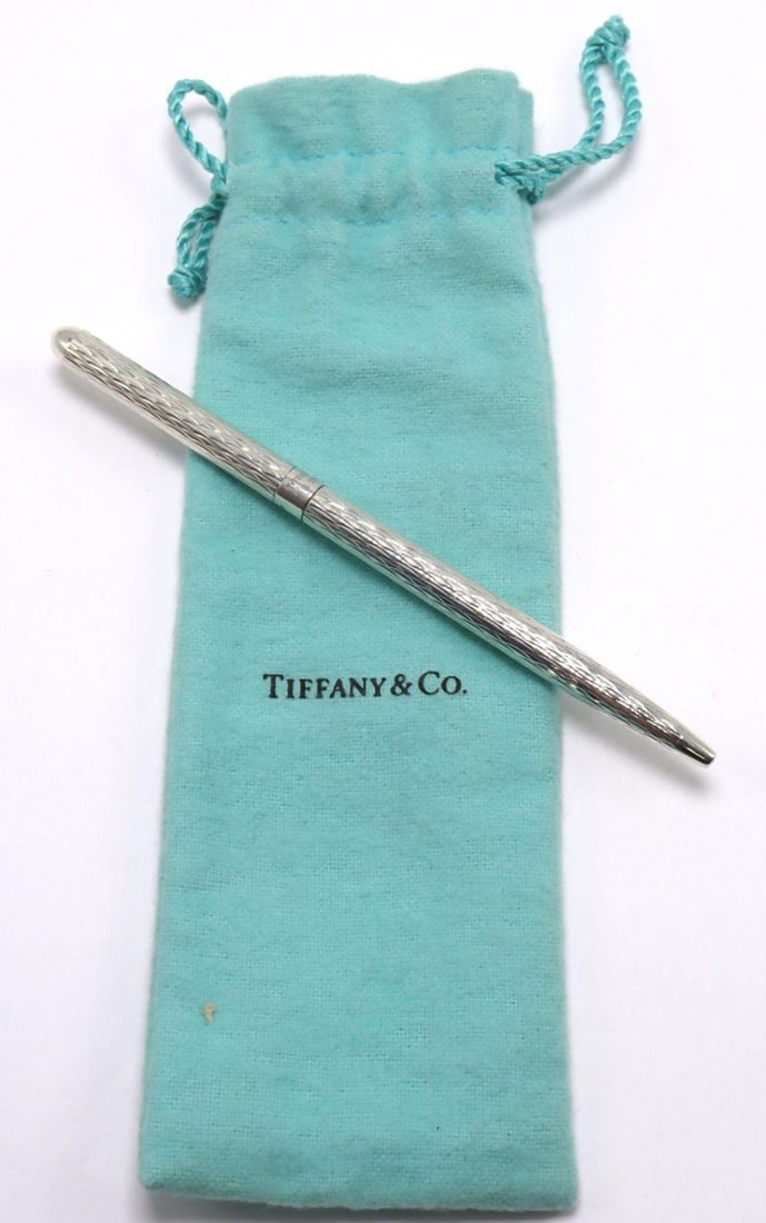 Tiffany & Co. Diamond Cut Sterling Silver Pen: Tiffany & Co. Diamond Cut Sterling Silver Purse Pen with Pouch Measurements: approx. 4 3/4" long Weight: approx. 0.40 troy oz A Tiffany & Co. sterling silver purse pen featuring a diamond 