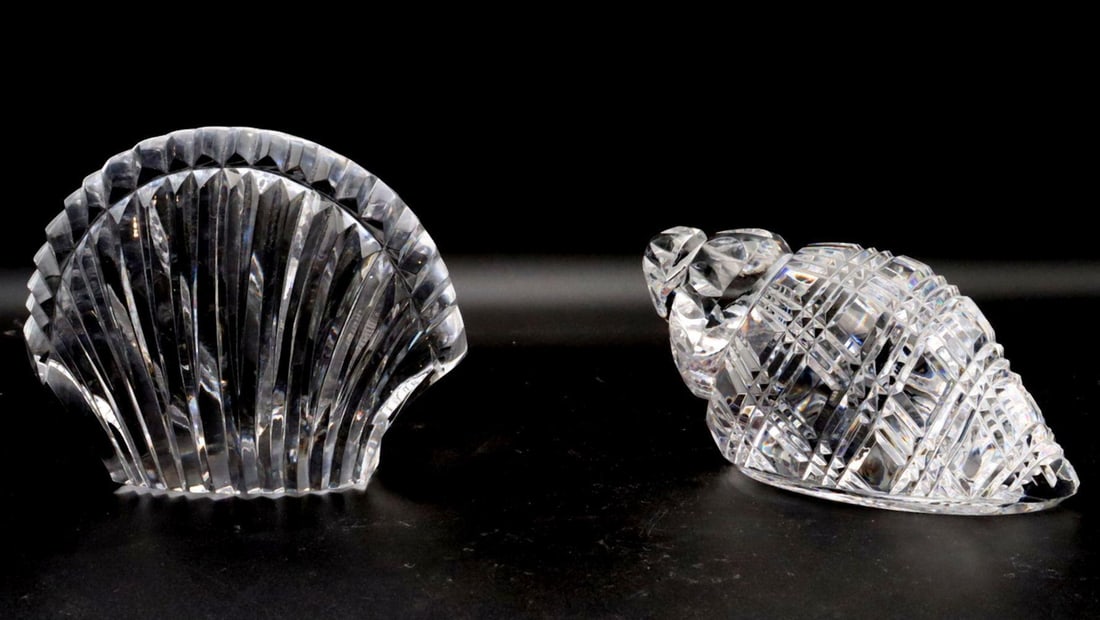 Two Waterford Cut Crystal Shells: Waterford Cut Crystal Shells, Pair Irish Contemporary Larger: 4" H x 5" W; Smaller: 3" H x 5" W A pair of Waterford cut crystal shells, each featuring faceted detailing and a stylized 