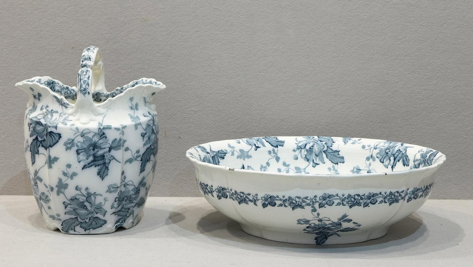 Furnival's England Floral Basket and Bowl: Furnival England Floral Basket and Bowl Set English 20th Century Basket: 12" H x 9.75" W; Bowl: 5" H x 16.5" L x 14" W A two-piece ceramic set comprising a handled basket and match