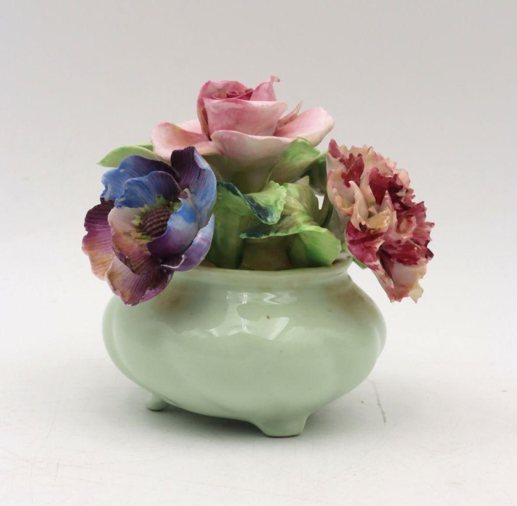 Radnor England Floral Porcelain China Sculpture: Radnor England Floral Porcelain China Sculpture 4" H x 4" W x 3" D A porcelain floral sculpture by Radnor England featuring finely detailed blossoms with hand-painted coloration and natura