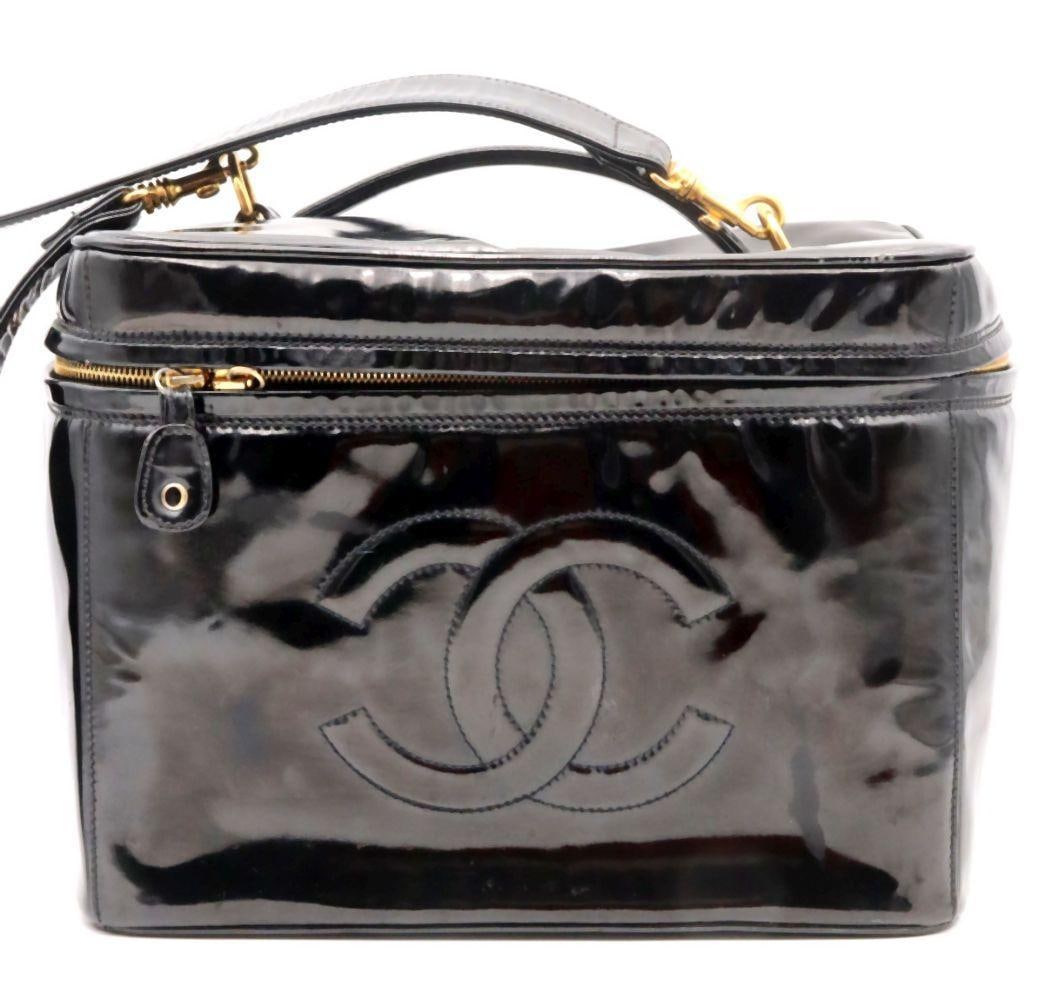 Chanel CC Vanity Patent Leather Cosmetic Bag: Chanel CC Vanity Patent Leather Cosmetic Bag. 12 1/2" W x 9" H x 8" D. A classic Chanel CC vanity cosmetic bag crafted in glossy black patent leather, featuring the iconic CC logo and a zi