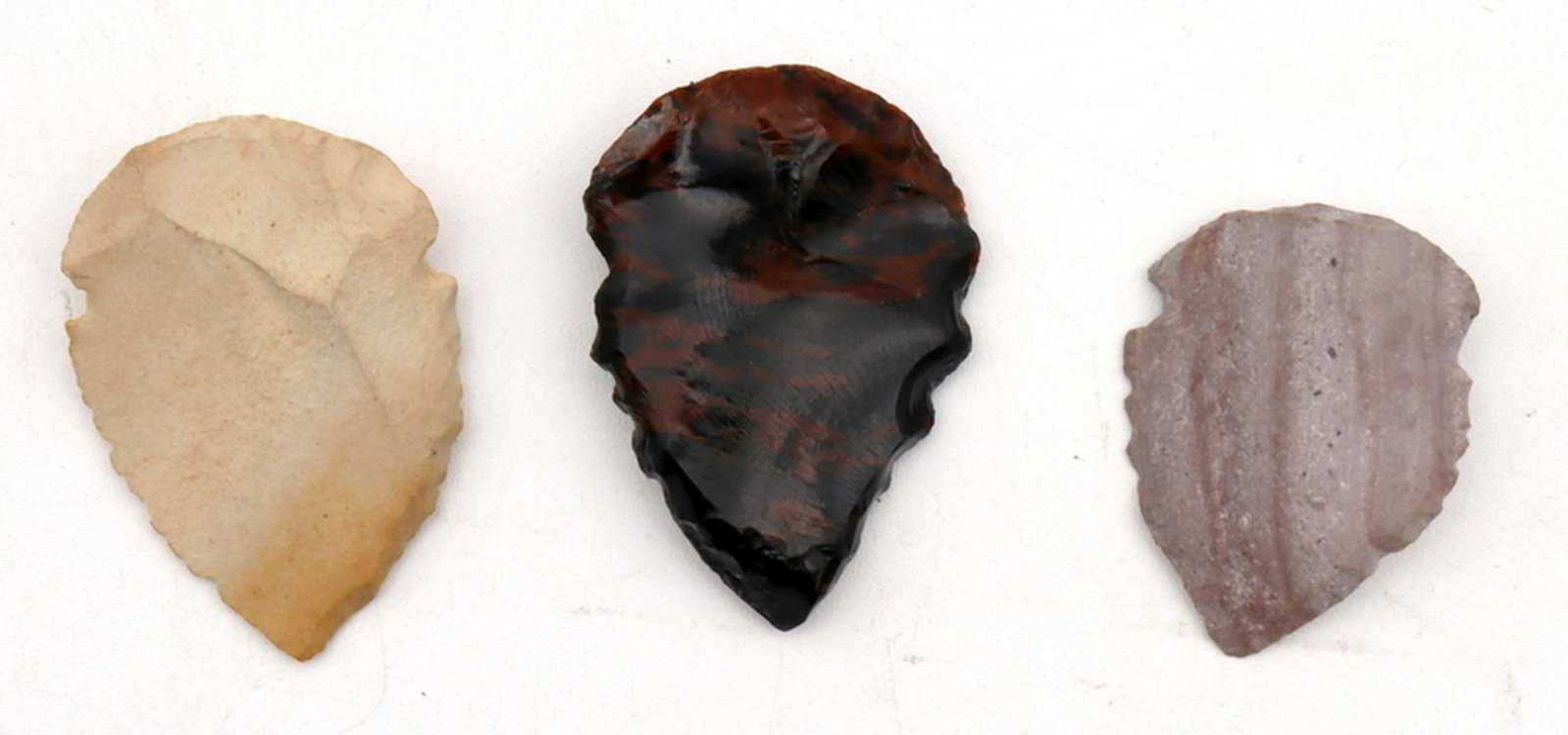 Lot of 3 Stone-Carved Arrowheads: Stone-Carved Arrowheads, Lot of 3 Each: 2" L x 1.25" W Detailing one darkened/polished arrowhead, a purple and lightly colored piece. Overall Good condition. Have a similar item to