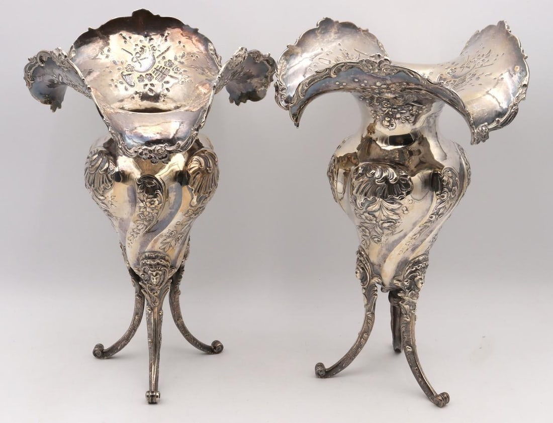 Pair of Early 20th C. Silver Plated Footed Vases: Pair of Early 20th C. Silver Plated Footed Vases Silver-plated metal, unmarked Each: 12.5" H x 8.5" W x 8.5" D Condition: Good condition with light tarnish to each. Have a similar item to