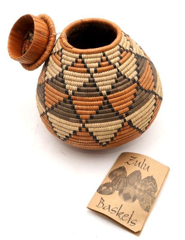South African Zulu Covered Baskets, Set of 3: South African Zulu Covered Baskets, Set of Three Woven fiber Largest: 8.5" H x 6.5" Dia. Each with informational tag identifying the weaver. Condition: Very good condition. Have a similar