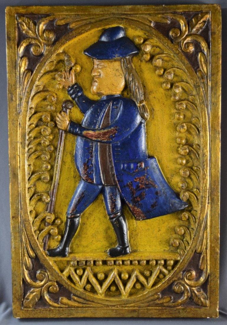 Karl Mann Associates Plaque (20TH Century): AMERICAN (20TH CENTURY) A gilt-wood hand painted plaque with a man in blue and label verso on back from Karl Mann Associates ( 24" x 16")