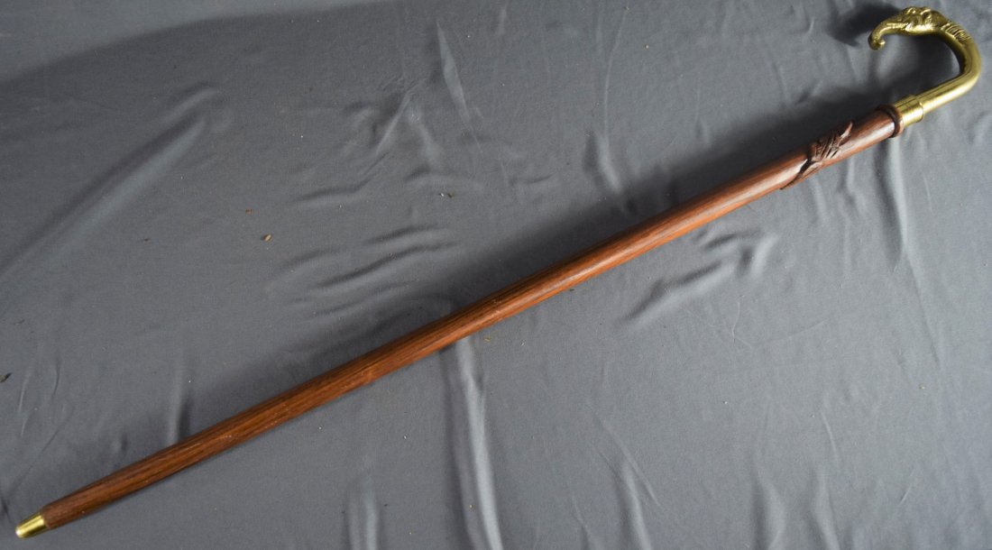 Wood Carved cane (Elephant): AMERICAN (20TH CENTURY) A vintage hand carved wood cane with gilt elephant head handle (36")
