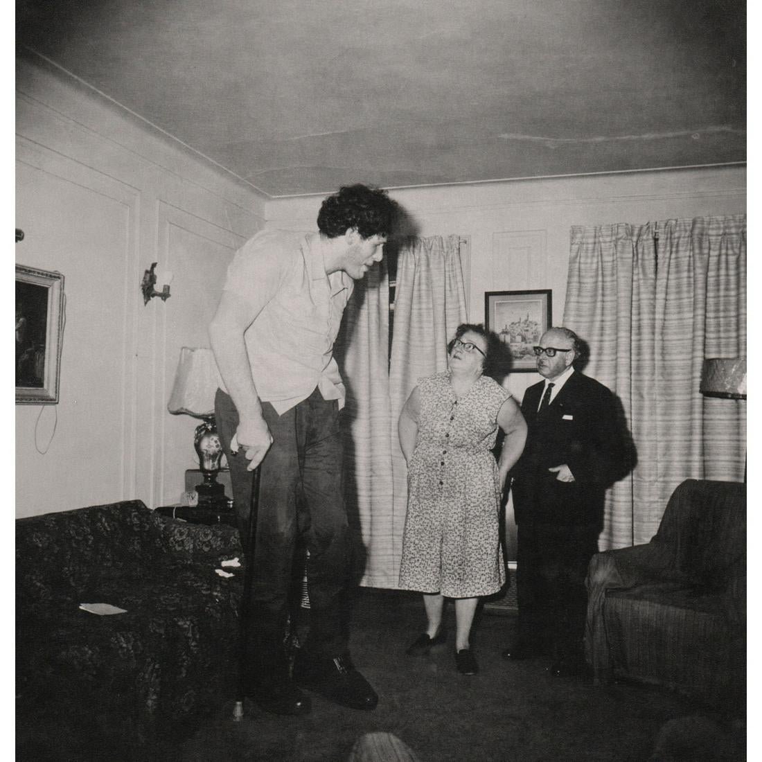 Diane Arbus - A Jewish Giant with his Parents, 1970: DIANE ARBUS (1923-1971) A Jewish Giant with his Parents, 1970 Photo-litho 8" x 8"