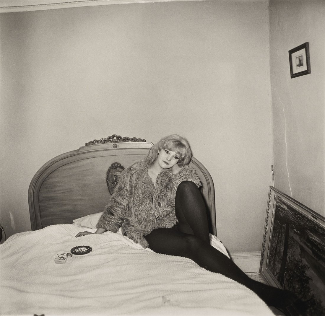 Diane Arbus - Girl in a coat on her bed, NYC, 1968: DIANE ARBUS (1923-1971) Girl in a coat lying on her bed, NYC, 1968 Photo-litho 7" x 7"