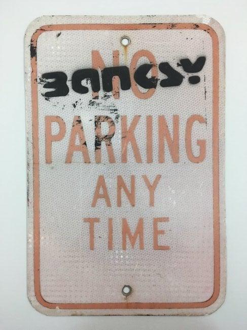 Banksy - Spray Paint Graffiti Signature on Parking Sign: ATTRIBUTED TO BANKSY (BRITISH) No Parking Any Time Spray paint on metal sign 18" x 12" Signed towards the top