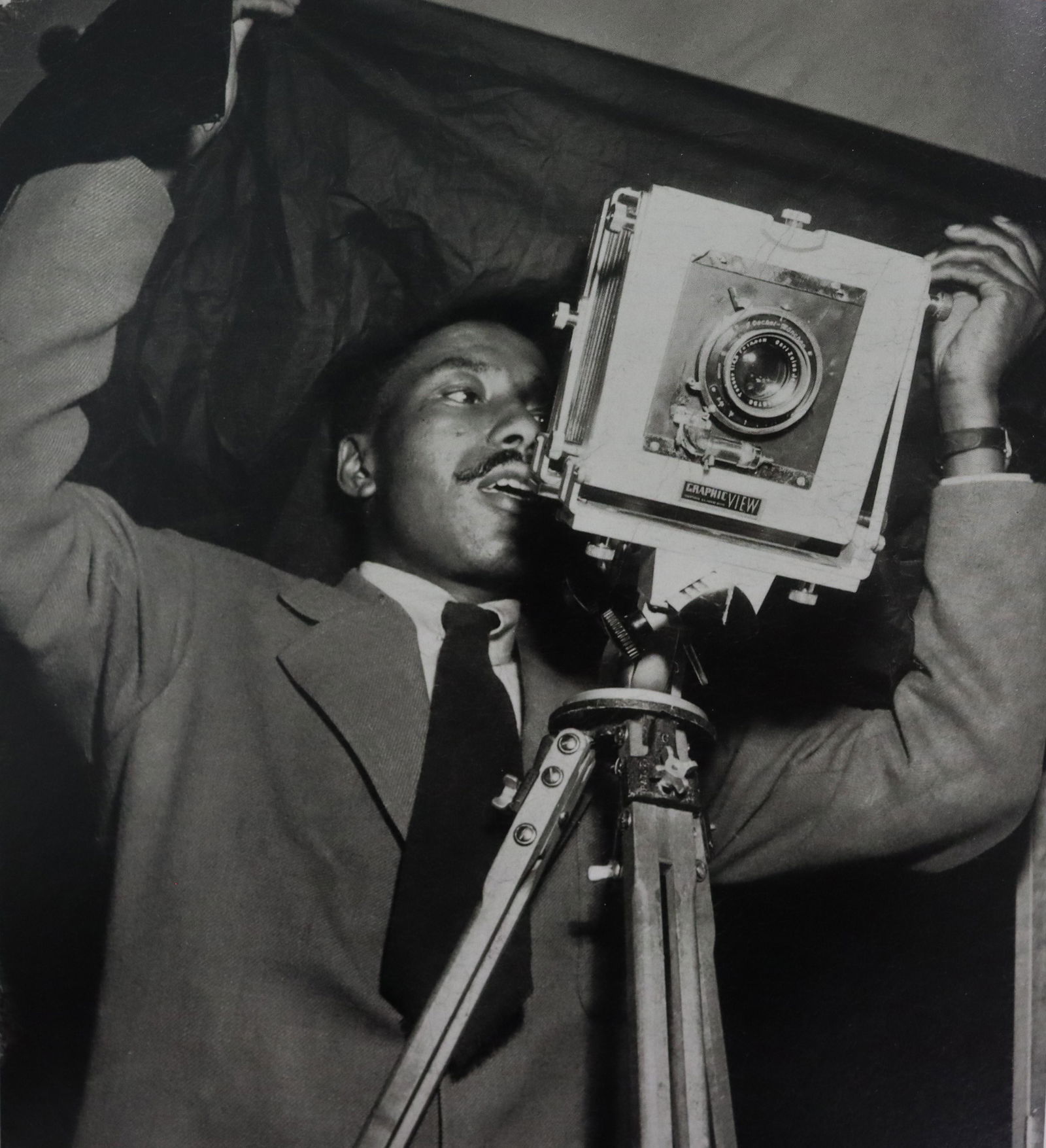 Gordon Parks Using Camera Photo-Litho: Unkown Photographer, Gordon Parks using large fortmat camera Photo-Litho Printed later 20th Century 7 3/4" x 7" (Image Size)