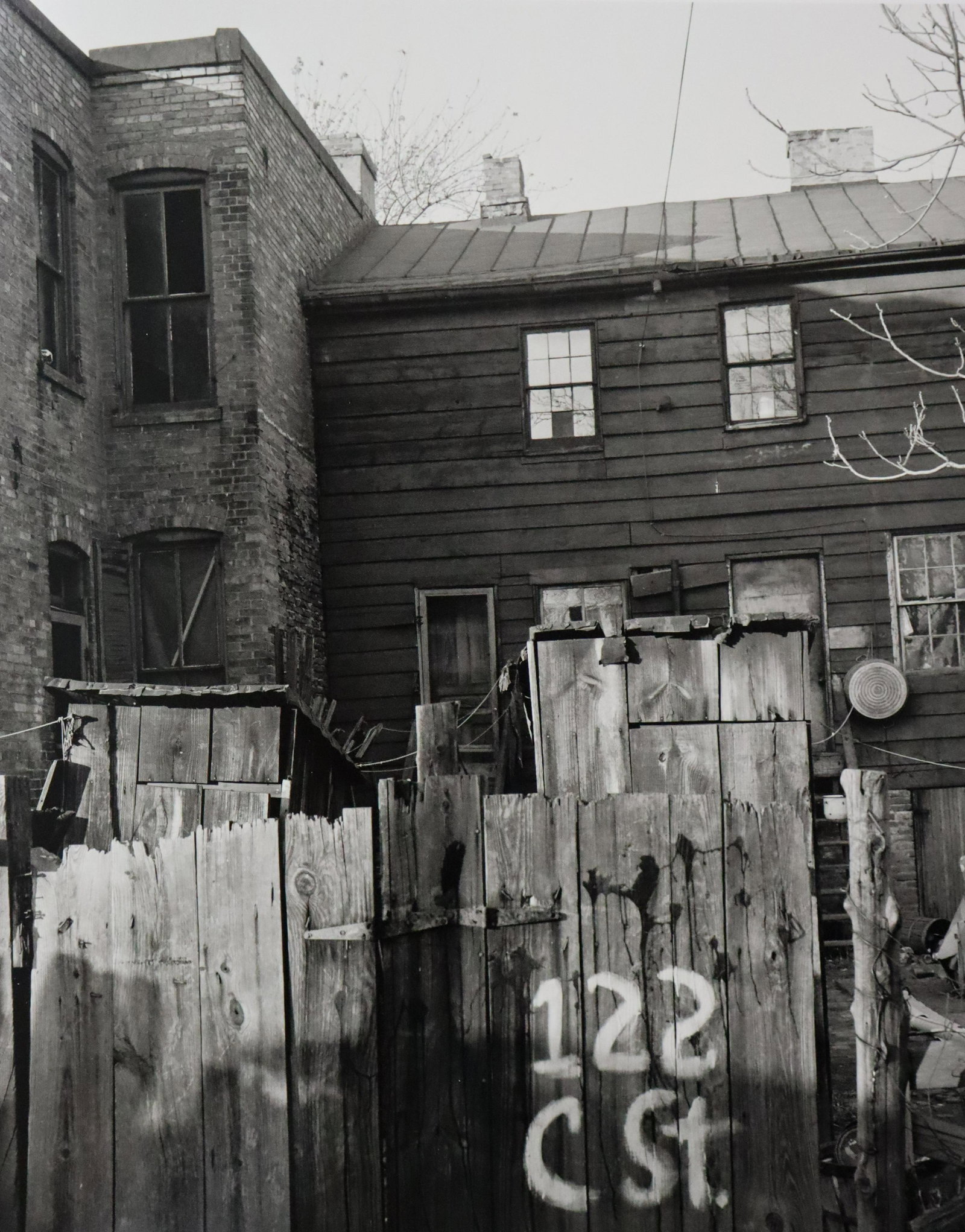 Gordon Parks - Wooden Privies, Photo-Litho: GORDON PARKS - (1912-2006) Wood Privies, Washington, D.C. Photo-Litho Printed later 20th Century 9" x 7" (Image Size)
