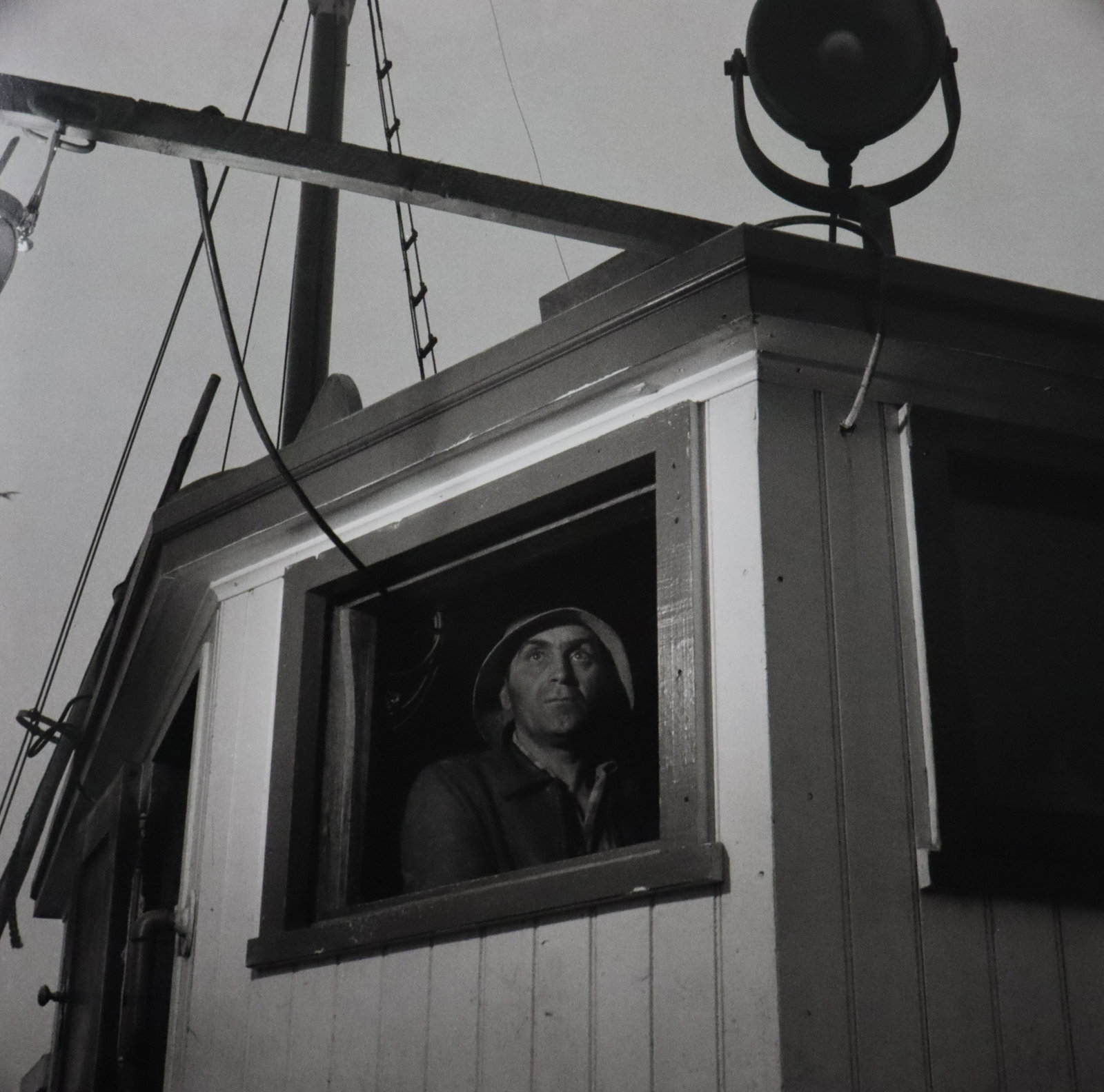 Gordon Parks - Lorenzo Scola Piltos Ship, Photo-Litho: GORDON PARKS - (1912-2006) Lorenzo Scola Pilots the Ship, Gloucester, Massachusetts Photo-Litho Printed later 20th Century 7" x 7" (Image Size)