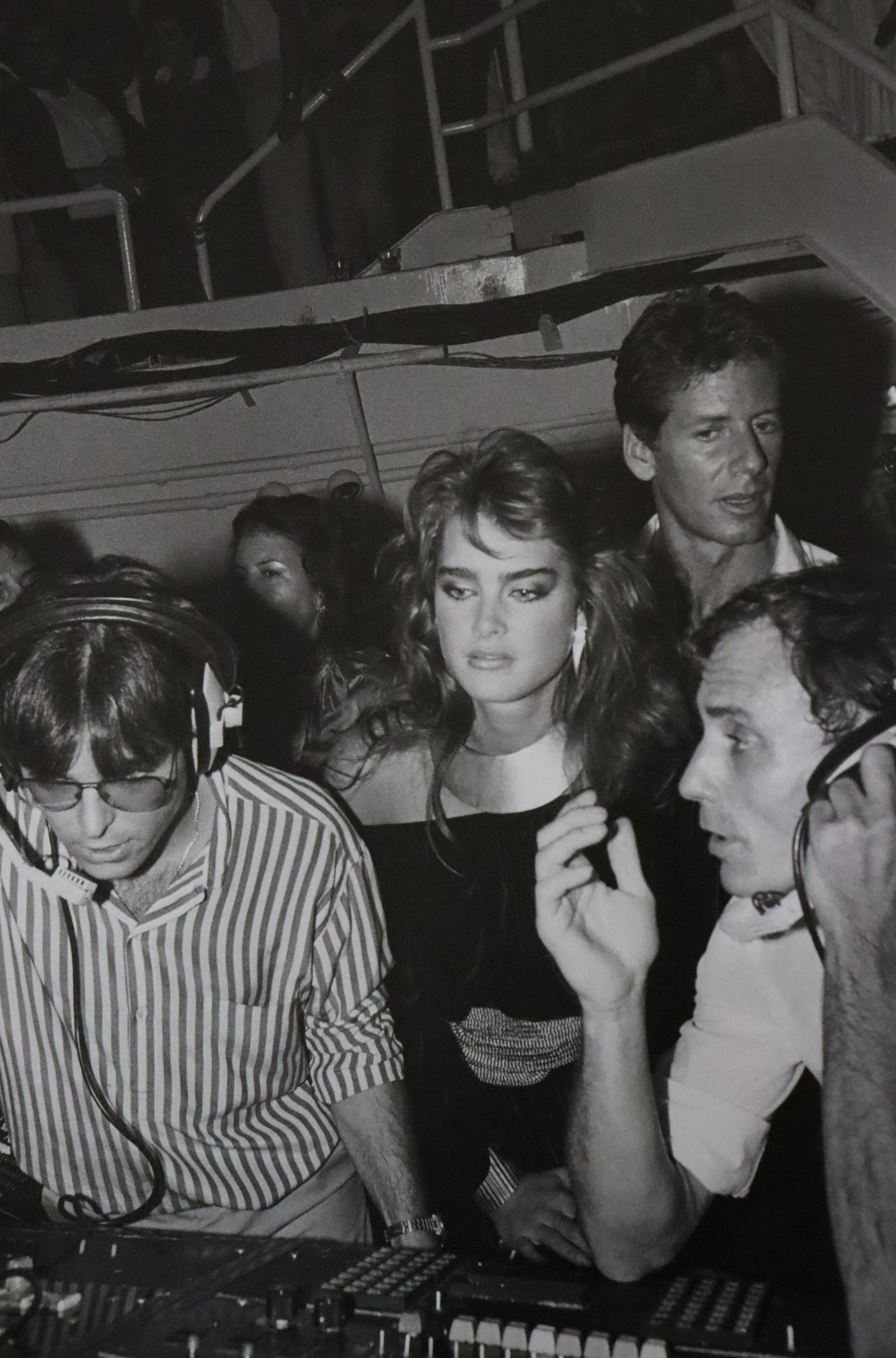 Ian with Brooke Shields, Studio 54, Photo-Litho: UNKNOWN PHOTOGRAPHER Ian with headphones calling the show in the DJ booth with Brooke Shields, Calvin Klein, and Robert DeSilva, Studio 54 Photo-Litho Printed circa late 20th century 13 5/8" x 8 3/4"