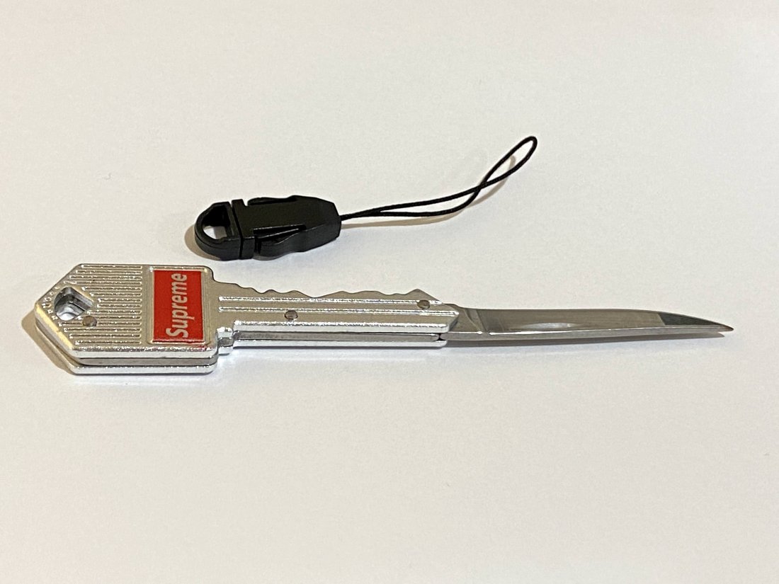 Supreme pocket knife: Silver with red Supreme issued pocket knife.