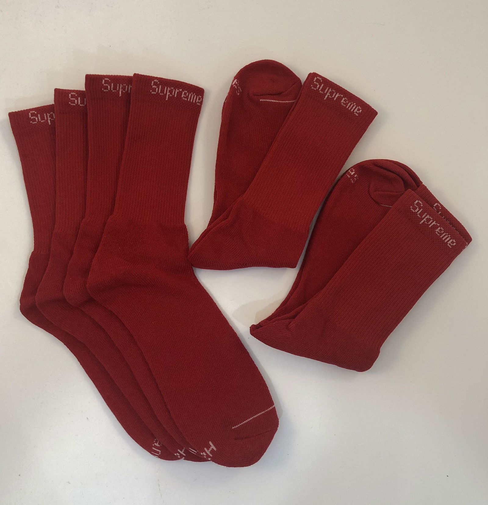 Supreme Cushion Crew Socks: SUPREME Cushion Crew Socks issued by Supreme Total of 4 pairs in red.