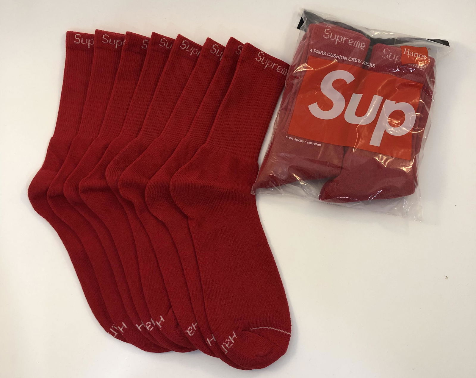 Supreme Cushion Crew Socks: SUPREME Cushion Crew Socks issued by Supreme Total of 8 pairs in red.