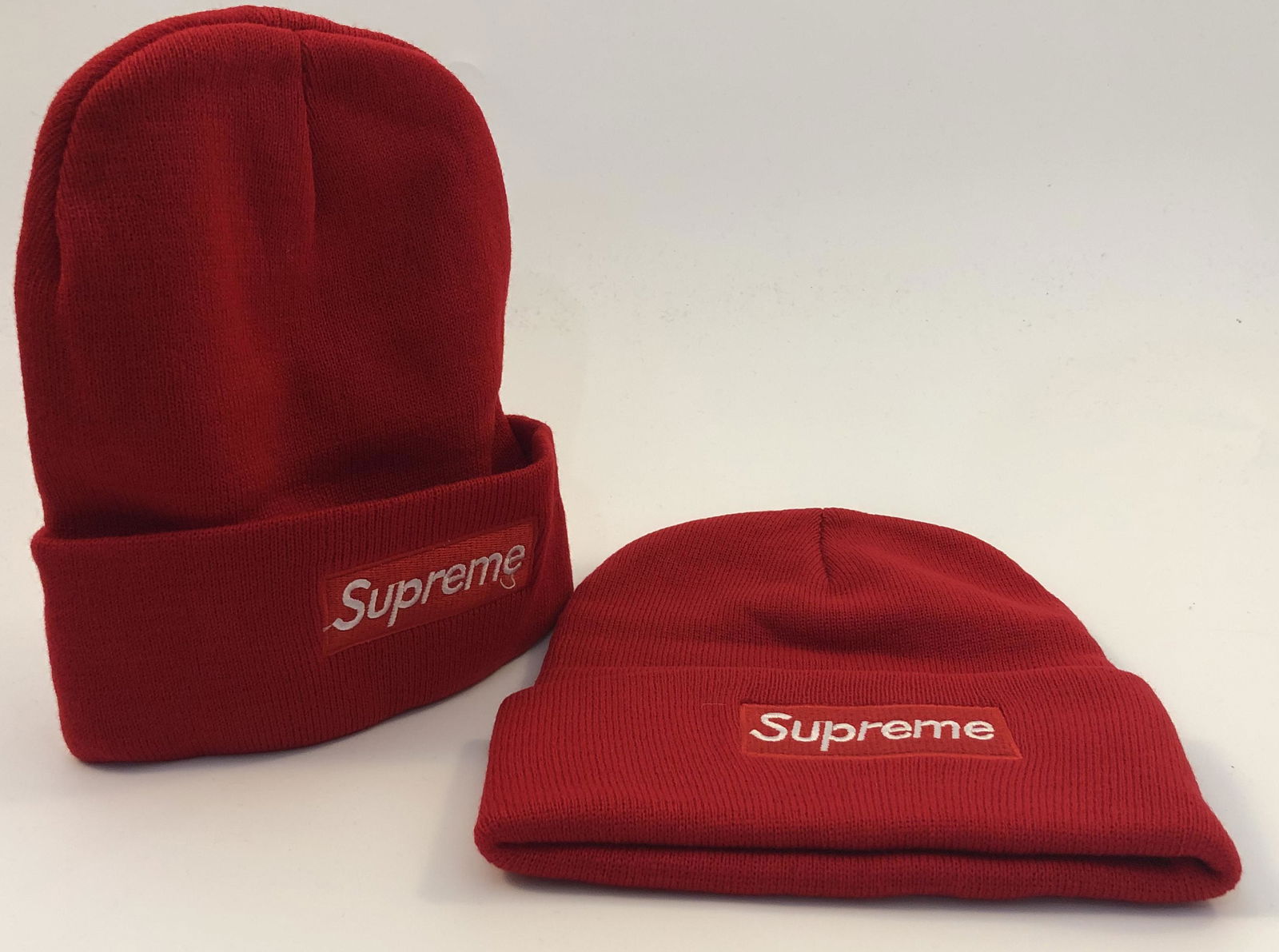 Supreme Winter Cap: SUPREME Winter caps issued by Supreme Total of 2 in red.