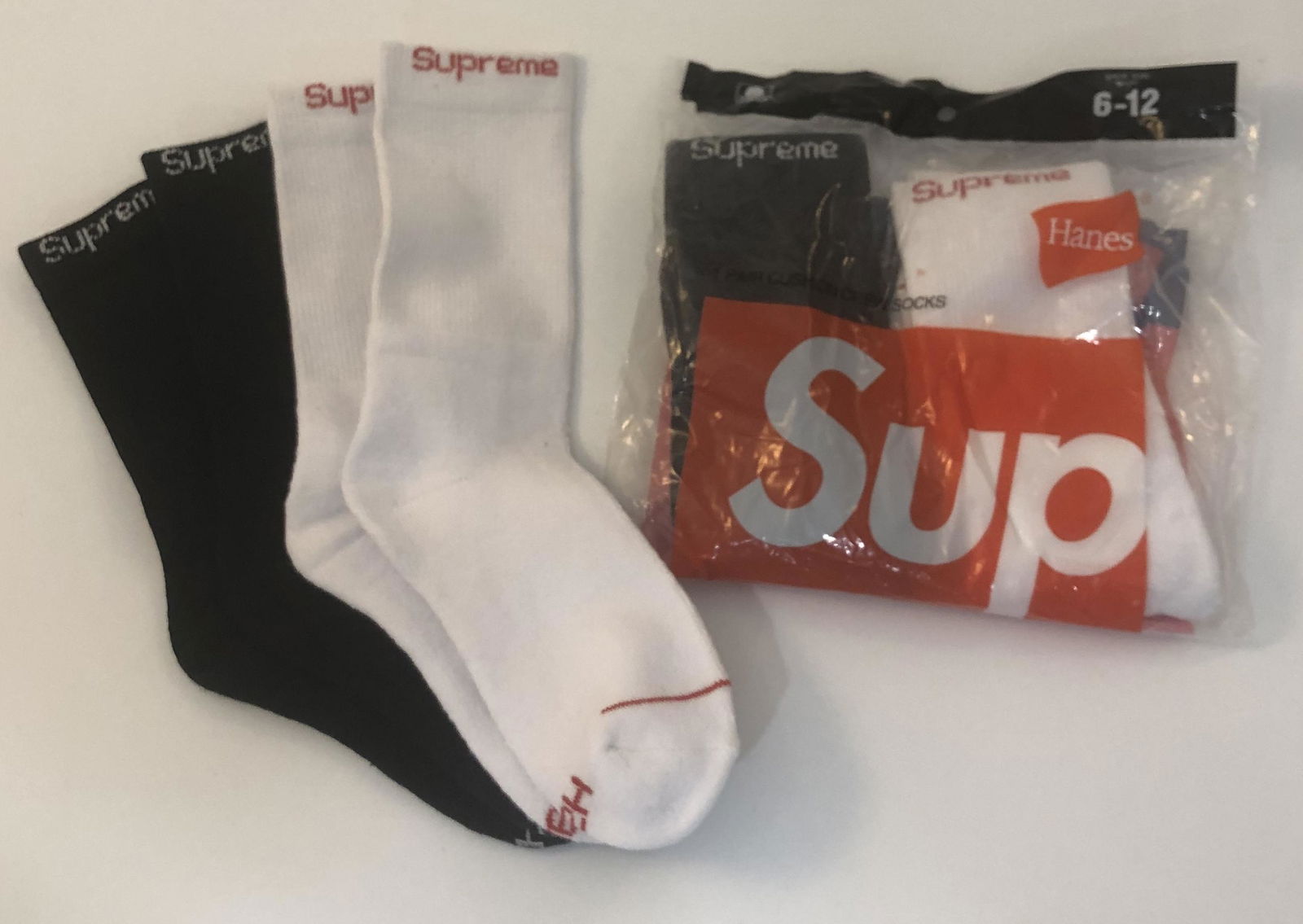 Supreme Cushion Crew Socks: SUPREME Cushion Crew Socks issued by Supreme Total of 4 pairs, 2 pairs in white and 2 pairs in black.