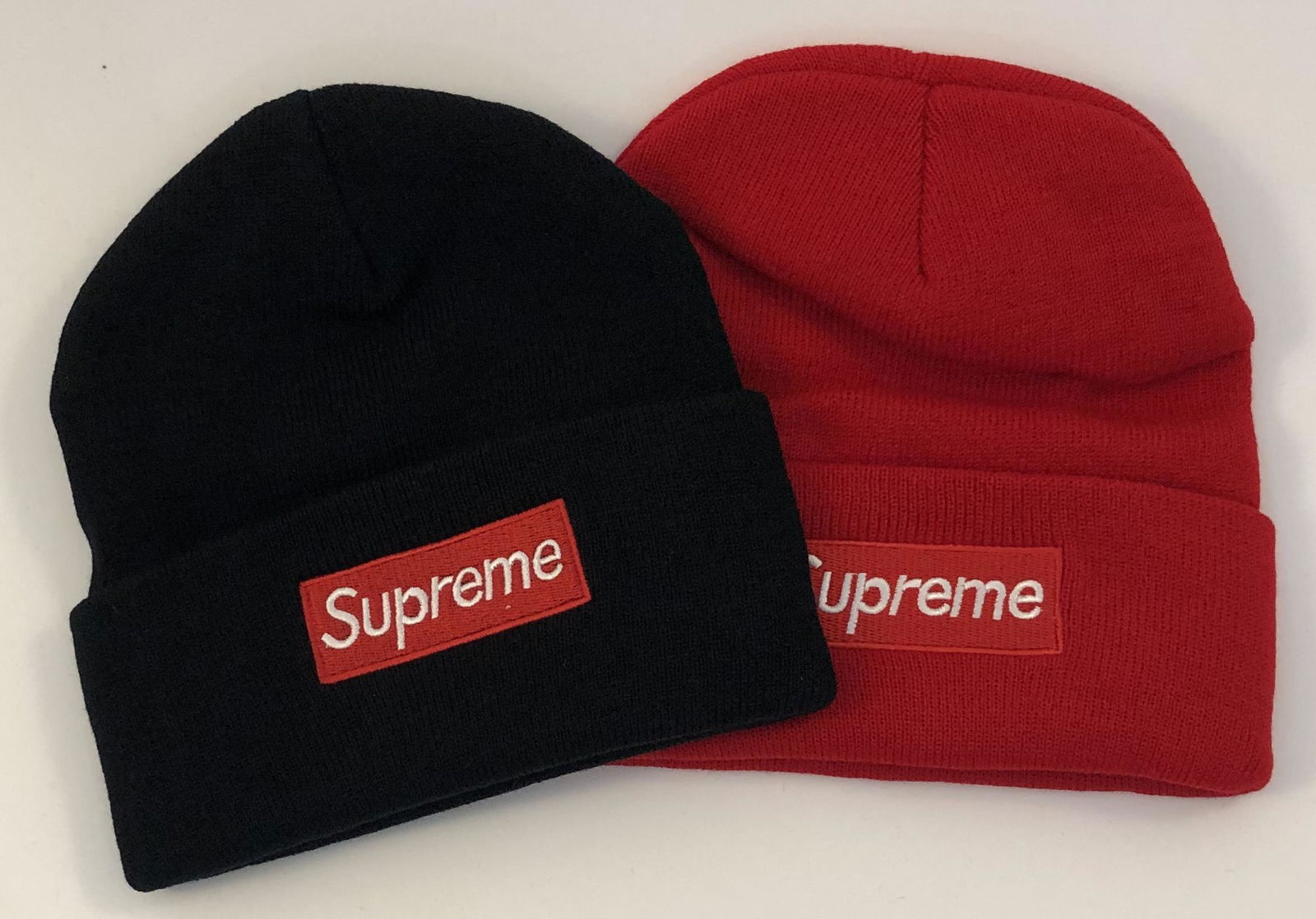 Supreme Winter Cap: SUPREME Winter caps issued by Supreme Total of 2, 1 in black and 1 in red.