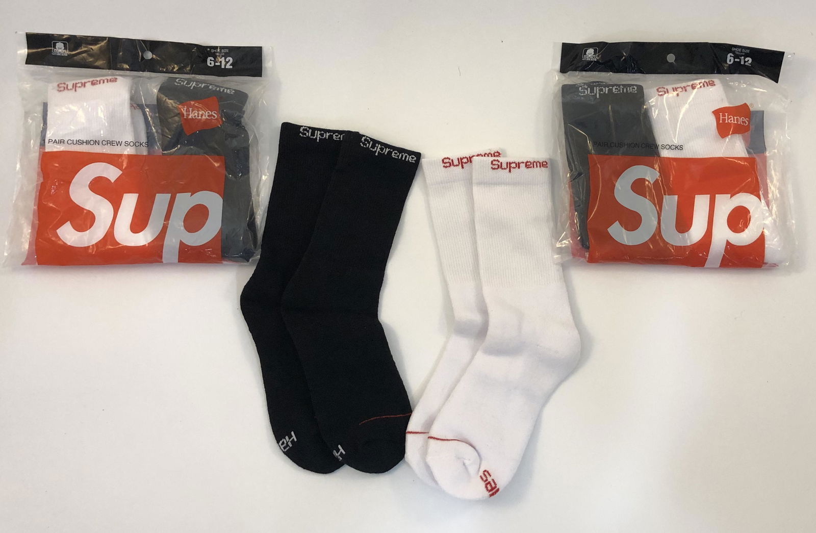 Supreme Cushion Crew Socks: SUPREME Cushion Crew Socks issued by Supreme Total of 6 pairs, 3 pairs in white and 3 pairs in black.