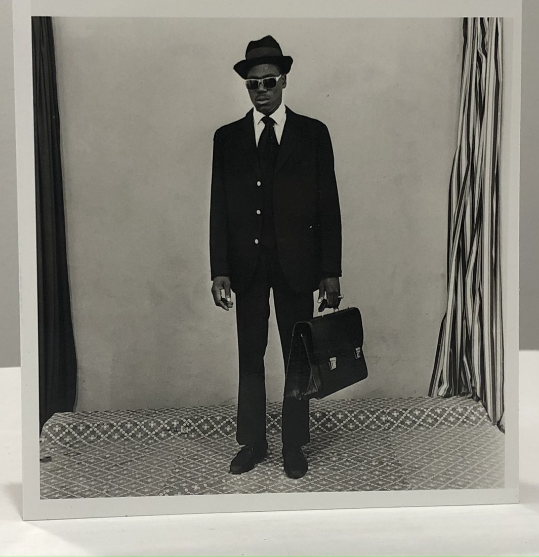 Malick Sidibe (Business Man) Glossy Photo-Litho: MALICK SIDIBE (1935-2016) Untitled (Business Man) Glossy photo-litho Printed circa later 20th c. 6 1/2" x 6 1/2" Mounted to same sized cardstock