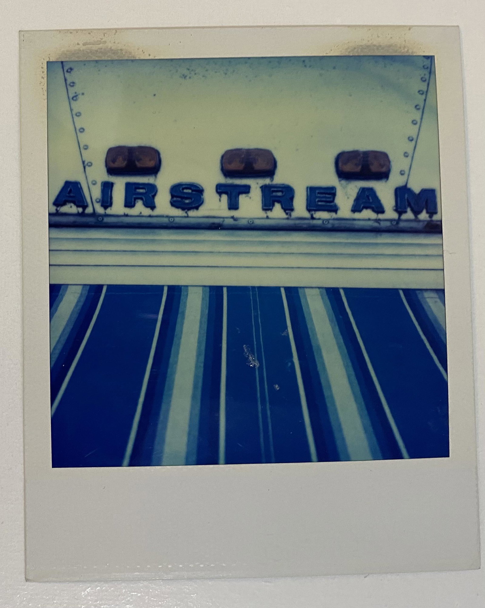 Andy Warhol (Airstream) Estate Stamped Photograph: ANDY WARHOL (1928-1987) Airstream Polaroid 4" x 3" Embossed to lower right side Stamped to verso "Authenticated - The Estate of Andy Warhol"