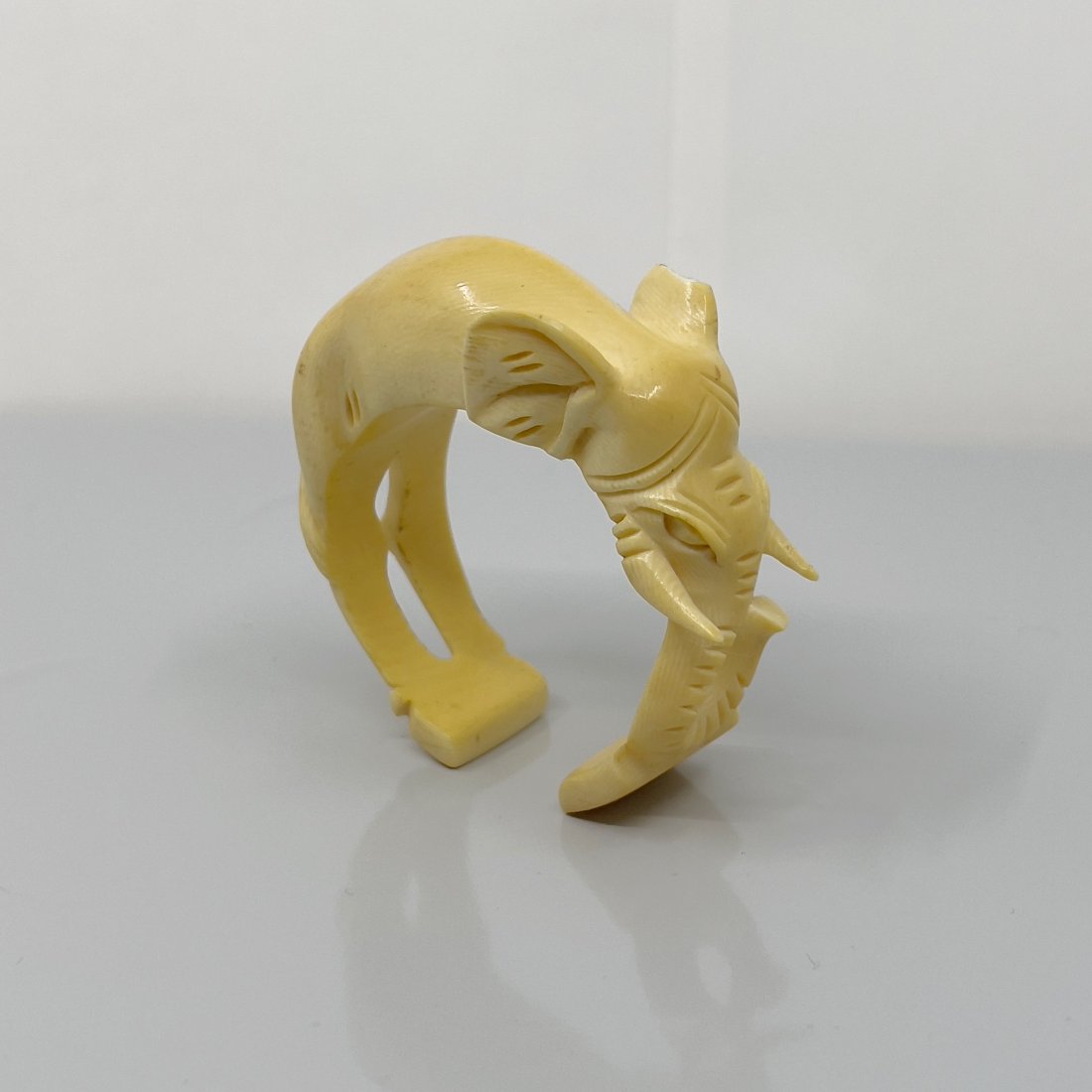 Art Deco carved elephant bone cuff: Bracelet will fit up to 6" wrist by 1 3/16" wide In good pre-owned condition Note: chip on one ear 