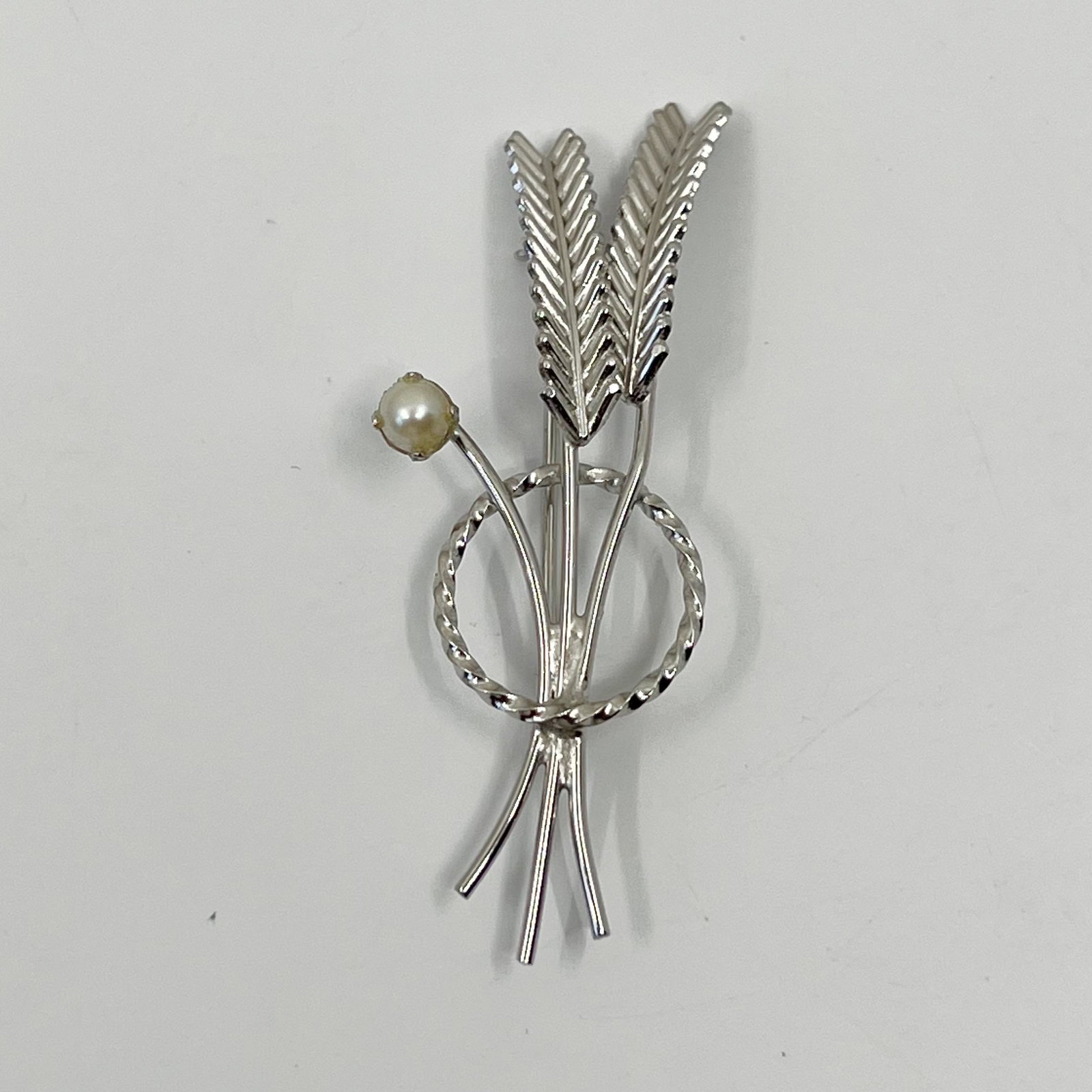 CR Co. Charles Ries sterling silver pearl brooch: Measures: 2 1/4" long by 7/8" wide Gemstone: 5mm akoya pearl Signed: Sterling CR Co In good pre-owned condition