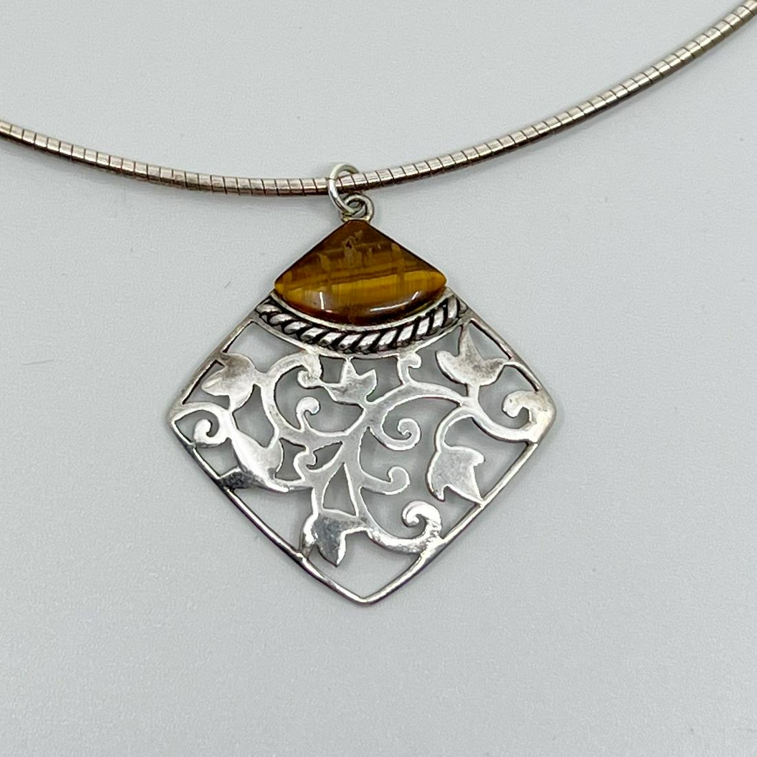 Sterling silver tiger eye pendant: Measures: 1 1/2" Long by 1 1/4" Wide Gemstones: tiger eye Material: sterling silver Signed: 925 Condition: like new SKU-325