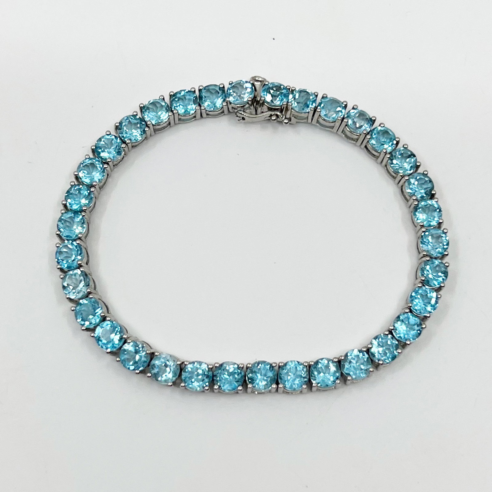 sterling silver blue topaz tennis bracelet: Measures: 7" long by 5mm wide Crafted with 5mm blur topaz Hallmark: 925 PM Condition: like new SKU-1224