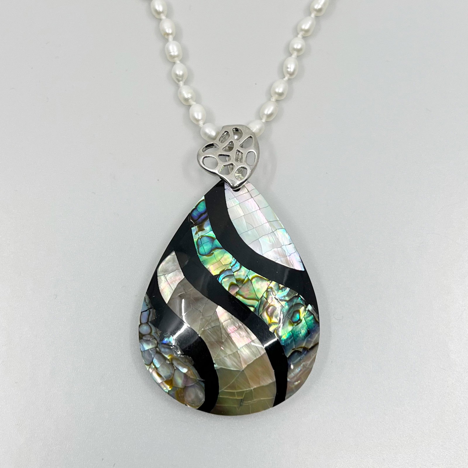 Sterling silver pearl & abalone inlay necklace: Chain: 18" long Pendant: 2 1/2" long by 1 5/8" wide Crafted with pearls, abalone & mother pearl inlay Condition: like new SKU-1551