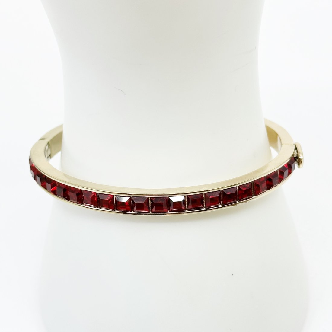 DKNY gold tone crystal bangle bracelet: bracelet measures 7" inner circumference by 6mm wide crafted with red crystals In very good condition SKU-1573