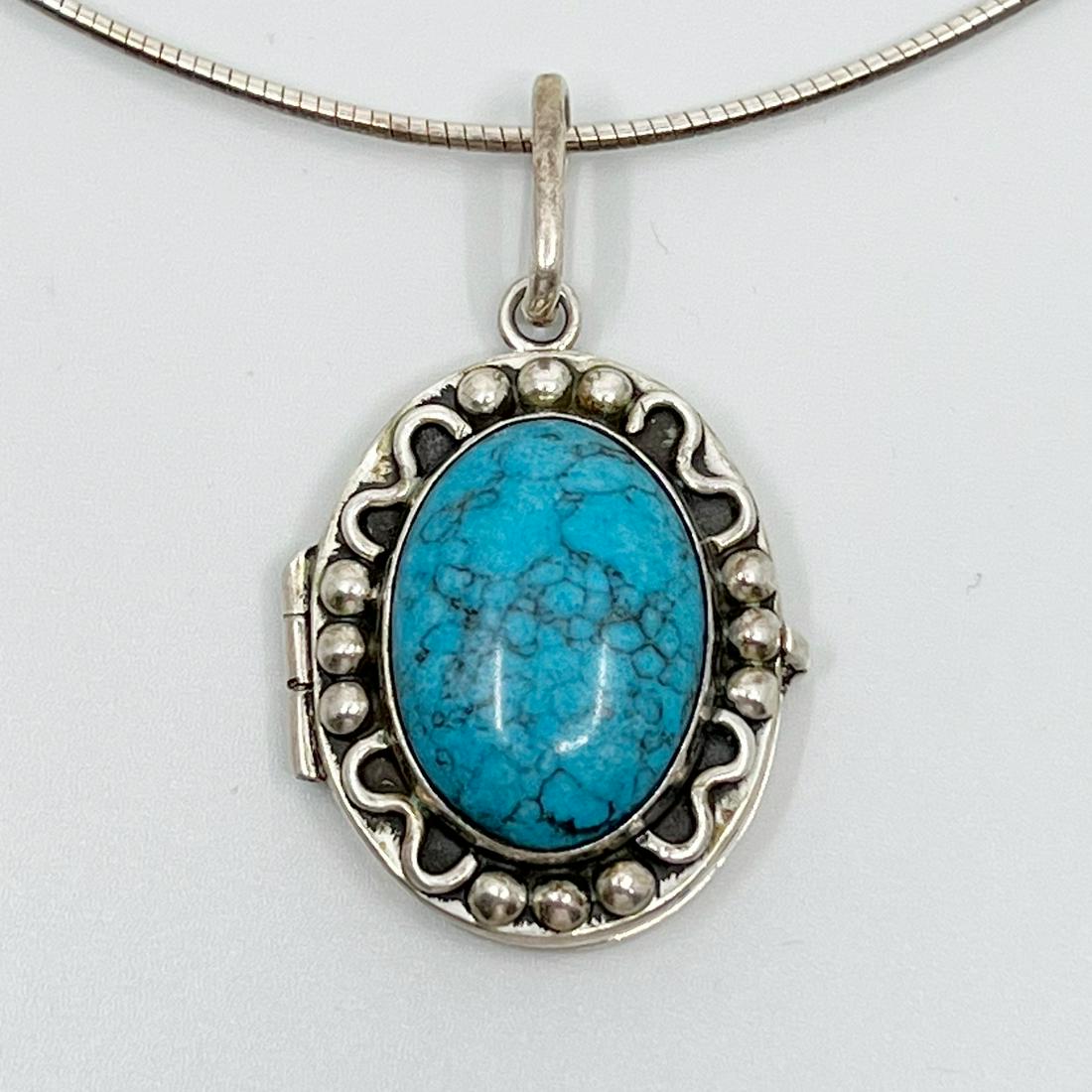 Mexican Sterling silver turquoise locket pendant: Measures: 2" Long by 1 1/4" Wide Gemstones: 24x17mm turquoise Material: sterling silver Signed: 925 Mexico Condition: like new SKU-3
