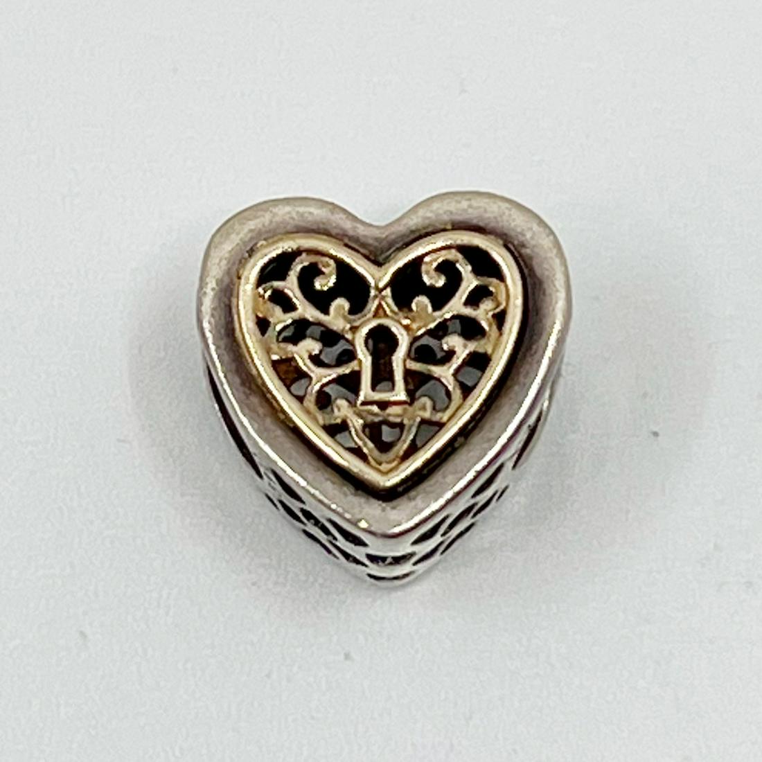 PANDORA sterling silver 14k gold locked heart charm: Measures: 11mm wide hallmark: 925 ale Condition: like new SKU-522